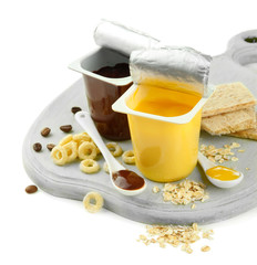 Tasty desserts in open plastic cups and honey combs, fruits and