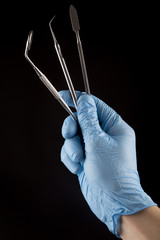 Hand with Dental Tools