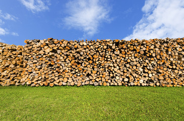 Pile of Chopped Firewood on Blue Sky