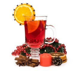 Mulled wine with spices and a candle