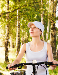 Woman riding bicycle outside.