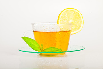 tea in cup with leaf mint and lemon