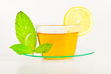 tea in cup with leaf mint and lemon