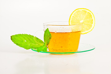tea in cup with leaf mint and lemon