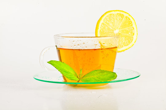 tea in cup with leaf mint and lemon