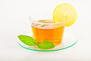 tea in cup with leaf mint and lemon