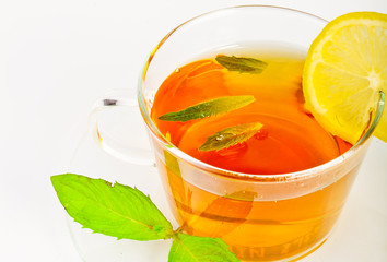 tea in cup with leaf mint and lemon