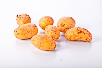 Little yellow patatos sliced on pure white background 