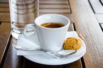 White espresso cup, biscuit and glass of water - 56595758