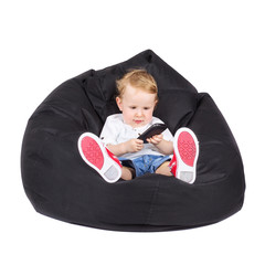 Adorable little boy holding smart phone sitting on lazy bag