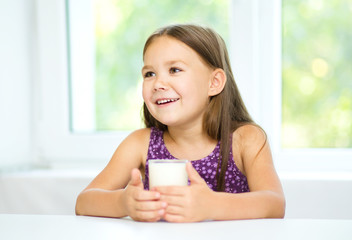 Cute little girl with a glass of milk