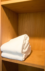 Fototapeta na wymiar white towel in shelf wood for spa