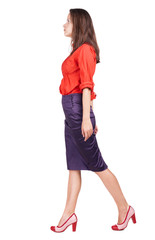 back view of walking woman in dress .