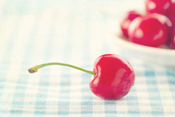 Red cherries on shabby chic blue background