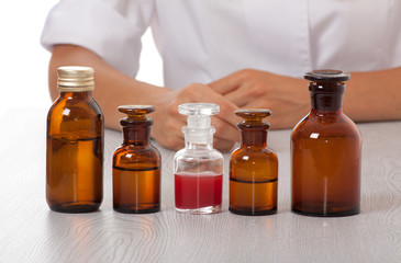 doctor's hand with bottles of medicine