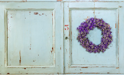 Lavender flower wreath hanging on an old door