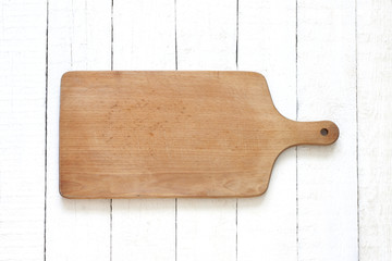 Empty cutting board on white planks food background concept
