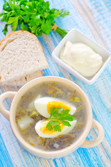 green soup with boiled eggs