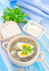 green soup with boiled eggs