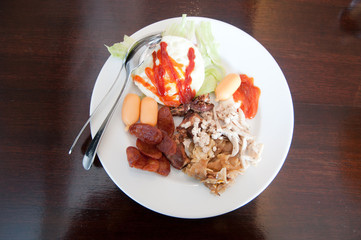 breakfast with egg, ham, bacon, sausage and vegetables