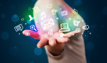 Young woman presenting colorful social media icons © ra2 studio