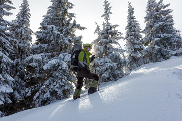 Hiker walking in winter Carpathian mountains