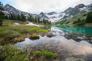 Naklejka na ściany i meble Beautiful mountain lake with reflection of nearest mountains