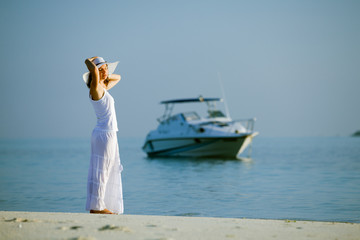 Fototapeta na wymiar Caucasian woman rests at beautiful seashore
