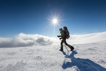 Naklejka na ściany i meble Hiker walking in winter Carpathian mountains