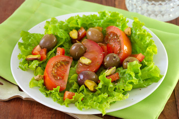 salad with pistachios on white plate