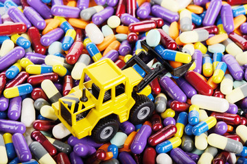 Industrial loader tractor toy load pills and tablets