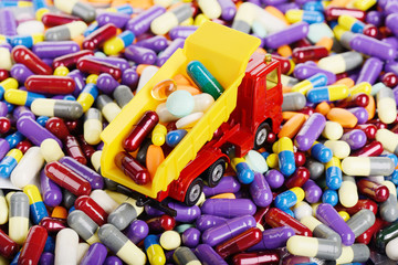 Dump truck toy unload pills and tablets