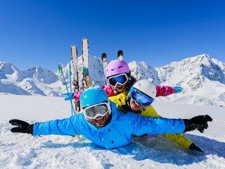 Ski, snow, sun and fun - family enjoying winter