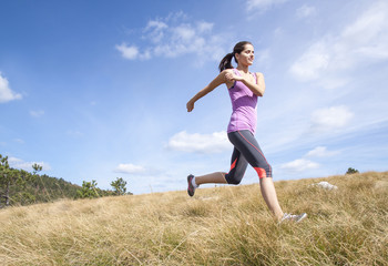 Young woman running outdoors in the nature