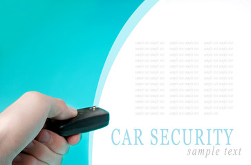 Hand holding car keys on blue background