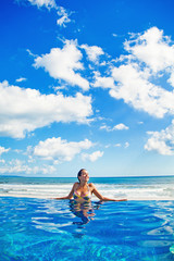 Fototapeta na wymiar woman relaxing in swimming pool
