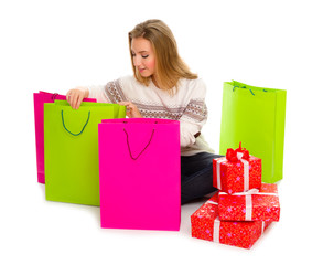 Fototapeta premium Young girl with bags and gift boxes