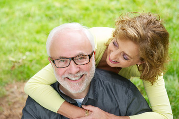 Happy older man with beautiful woman smiling outdoors