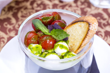 tomatoes and cheese in a glass bowl
