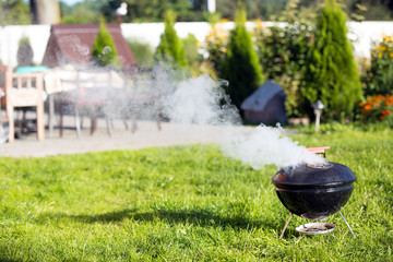 Сooking with kettle barbecue during picnic