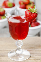 Strawberry drink on wooden table. Fresh, raw strawberries in the