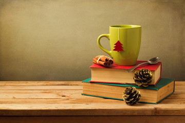 Christmas tea mug on books on wooden table
