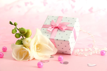Beautiful romantic gift box and flower on pink background