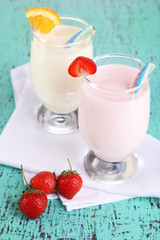Delicious milk shakes with orange and strawberries