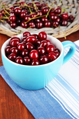 Sweet cherry in cup on table close-up