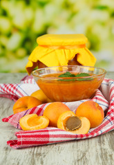 Apricot jam in glass bowl and fresh apricots,