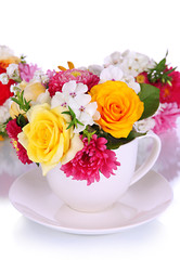 Beautiful bouquet of bright flowers in color mug, isolated