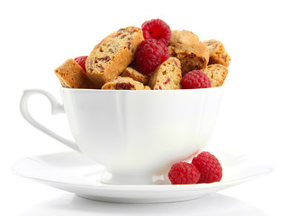 Tasty cookies with raspberries in cup isolated on white