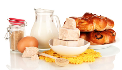 Dry yeast with pastry and baking ingredients isolated on white