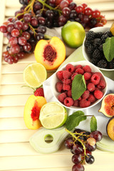 Assortment of juicy fruits and berries on wooden background